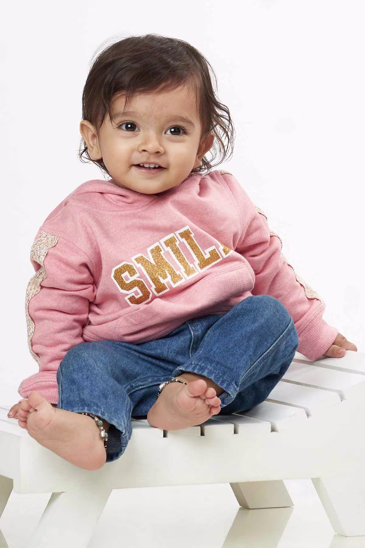 Monochrome-themed baby outfit on crawling girl Ikshu in Adzo Studio shoot