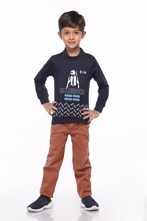 Boy sitting in brown jeans and full sleeves shirt by Adzo Studio