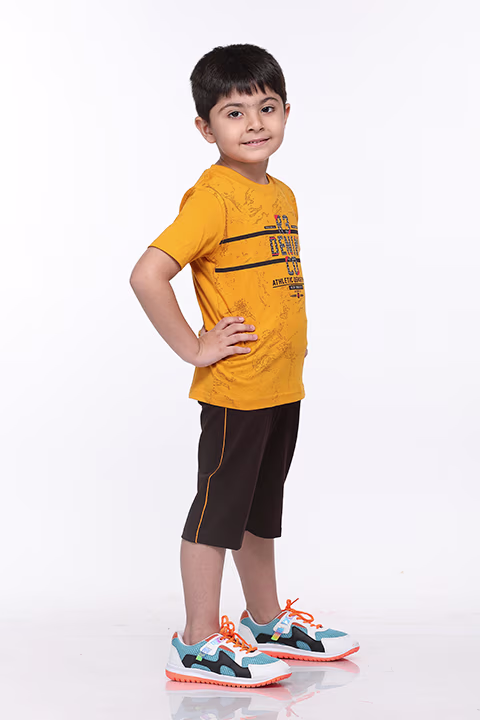 Bright yellow T-shirt and navy shorts shoot by Adzo Studio